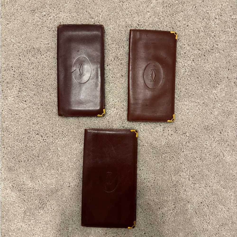 Bundle of Cartier Checkbook wallets in burgundy leather